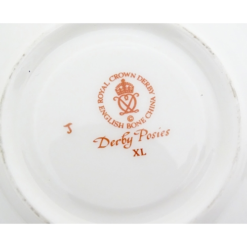 118 - A quantity of Royal Crown Derby tea wares in the Derby Posies pattern to include milk jug, twin hand... 