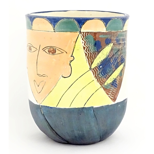 125 - A studio pottery jardiniere / planter / vase with modernist face and patterned decoration. Indistinc... 