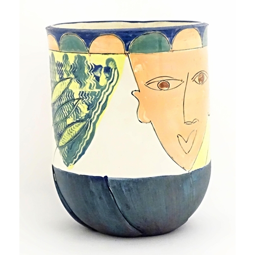 125 - A studio pottery jardiniere / planter / vase with modernist face and patterned decoration. Indistinc... 