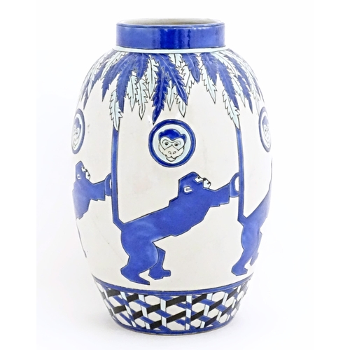 127 - An Art Deco style blue and white vase decorated with banded monkey and palm tree detail. Marked Kera... 