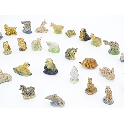 138A - A quantity of Wade Whimsies etc. to include to include dolphin, hedgehog, owl, dogs, birds, giraffe,... 