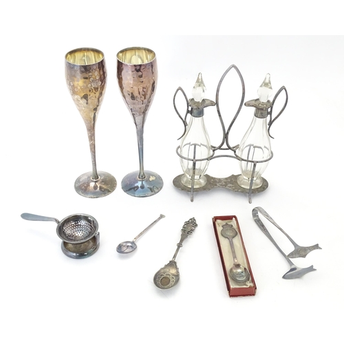 526 - A quantity of silver plated wares to include an oil and vinegar cruet, sardine servers, spoons, a te... 