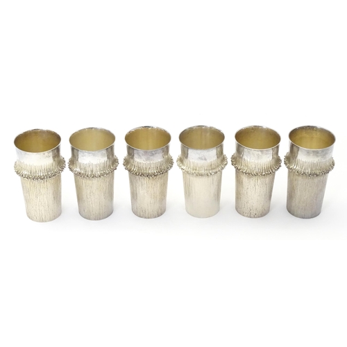 268 - Christopher Nigel Lawrence : An Elizabeth II Modernist set of six silver beakers / cups with texture... 