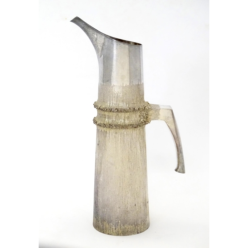 269 - Christopher Nigel Lawrence : An Elizabeth II Modernist silver ewer / pitcher / jug with textured bod... 