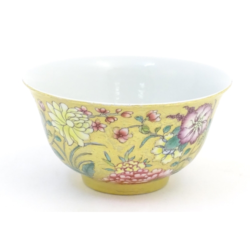 40A - A Chinese famille rose small bowl with a gilt ground decorated with flowers and foliage. Character m... 
