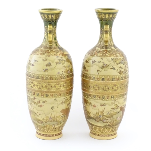 42A - A pair of Japanese satsuma vases with twin handles decorated with flowers, foliage, birds, etc. with... 