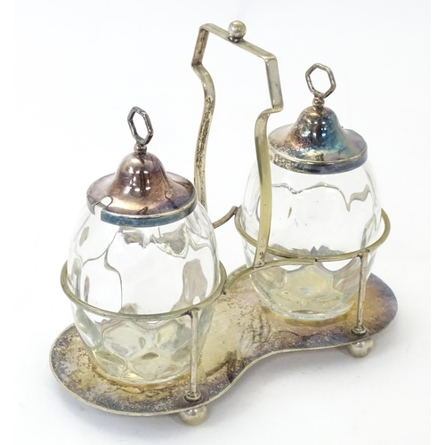 531 - A silver plate preserve stand with a pair of glass jars with silver plate tops. Approx. 8