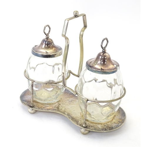 531 - A silver plate preserve stand with a pair of glass jars with silver plate tops. Approx. 8