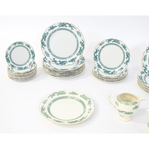 150 - A quantity of dinner wares in the Dragon pattern, to include dinner plates, side plates, milk jugs, ... 