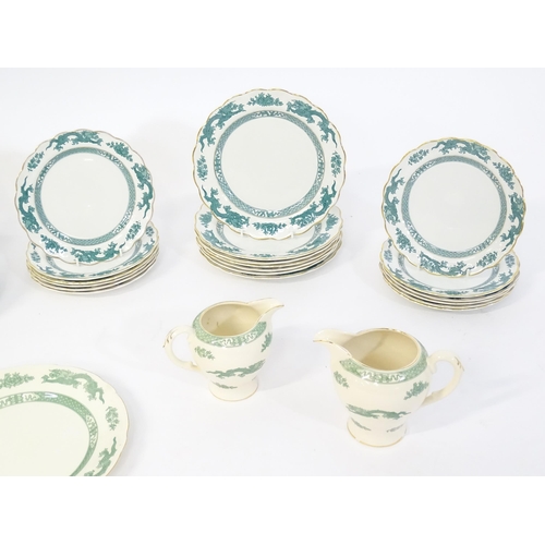 150 - A quantity of dinner wares in the Dragon pattern, to include dinner plates, side plates, milk jugs, ... 