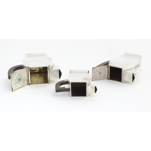 961 - An Art Deco three piece silver plate tea set with hammered decoration and wooden handles, comprising... 