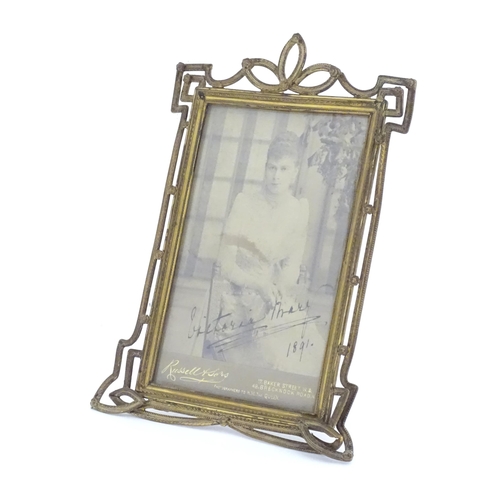 969 - A Victorian brass easel back photo frame with floral detail. Approx. 8 3/4