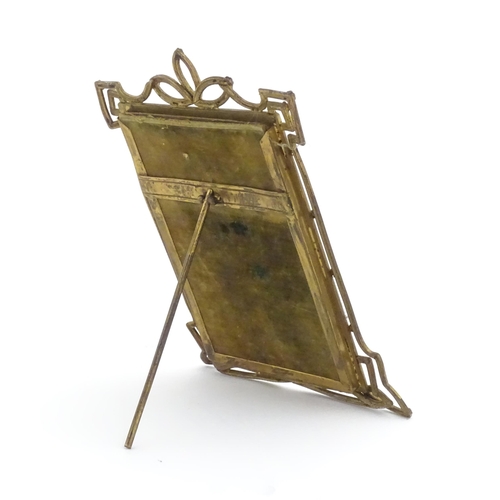 969 - A Victorian brass easel back photo frame with floral detail. Approx. 8 3/4