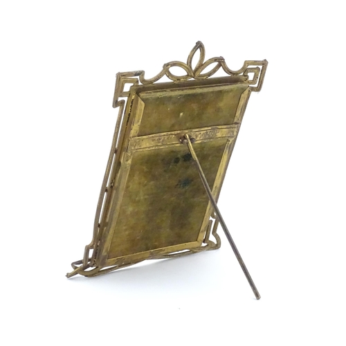 969 - A Victorian brass easel back photo frame with floral detail. Approx. 8 3/4