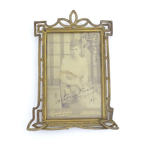 969 - A Victorian brass easel back photo frame with floral detail. Approx. 8 3/4