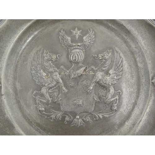 975 - A pewter charger with shaped rim and central heraldic crest / coat of arms. Impressed crowned rose t... 