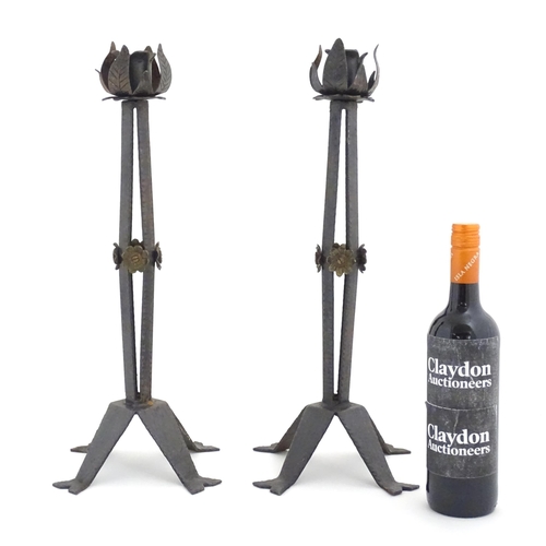 976 - A pair of Arts & Crafts style wrought iron lamps with foliate detail to top and brass rosette detail... 