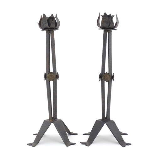 976 - A pair of Arts & Crafts style wrought iron lamps with foliate detail to top and brass rosette detail... 