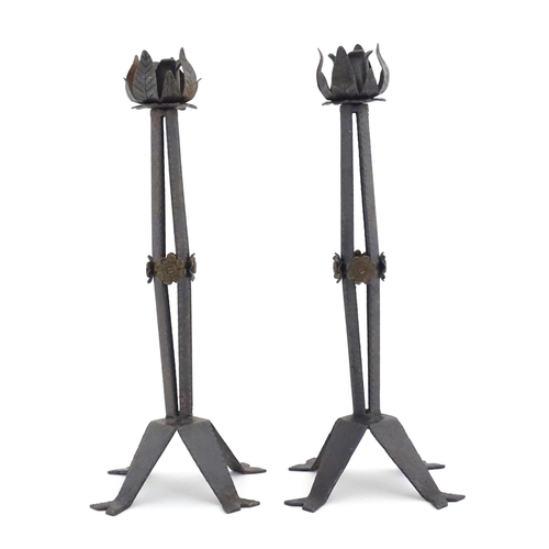 976 - A pair of Arts & Crafts style wrought iron lamps with foliate detail to top and brass rosette detail... 