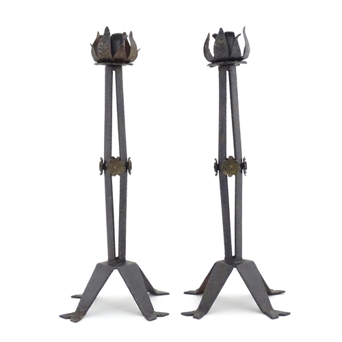 976 - A pair of Arts & Crafts style wrought iron lamps with foliate detail to top and brass rosette detail... 