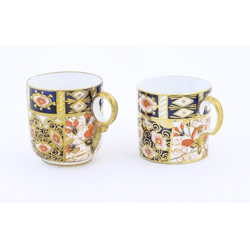 116A - A Royal Crown Derby coffee cup and saucer decorated in the Imari pattern. Marked under no. 2451. Tog... 