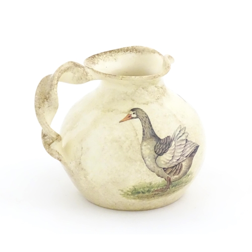 75A - A Yorkshire Moorlands pottery jug with twist handle decorated with geese. Marked under. Approx. 4 1/... 