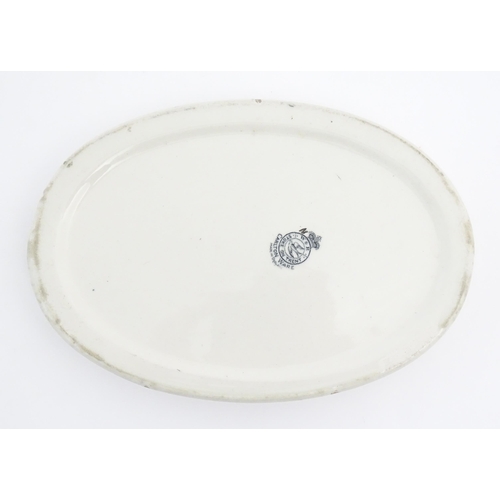 141A - A Carlton Ware oval baby plate depicting Old Mother Hubbard. Marked under. Approx. 6 1/4