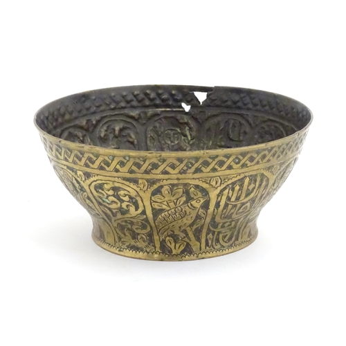 1000 - An Islamic brass bowl with embossed and engraved decoration depicting figures with weapons / arms, b... 