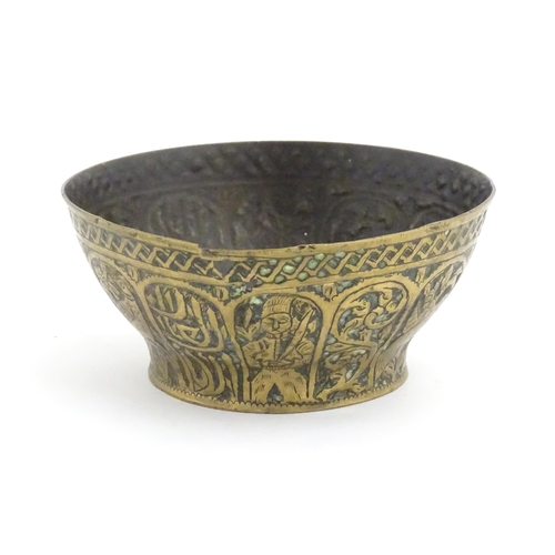 1000 - An Islamic brass bowl with embossed and engraved decoration depicting figures with weapons / arms, b... 