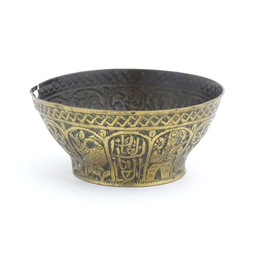 1000 - An Islamic brass bowl with embossed and engraved decoration depicting figures with weapons / arms, b... 