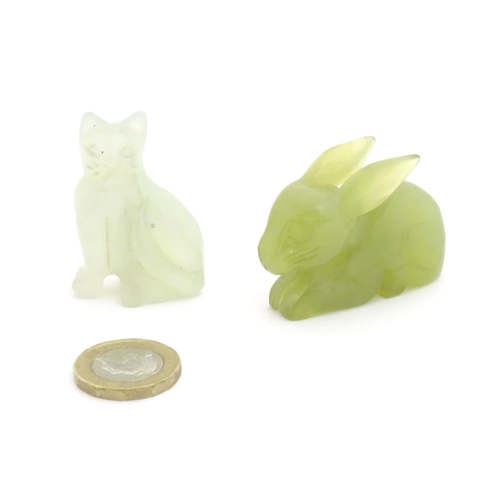 1011 - An Oriental carved jadeite model of a rabbit. Together with a carved bowenite model of a seated cat.... 