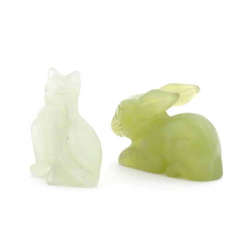 1011 - An Oriental carved jadeite model of a rabbit. Together with a carved bowenite model of a seated cat.... 