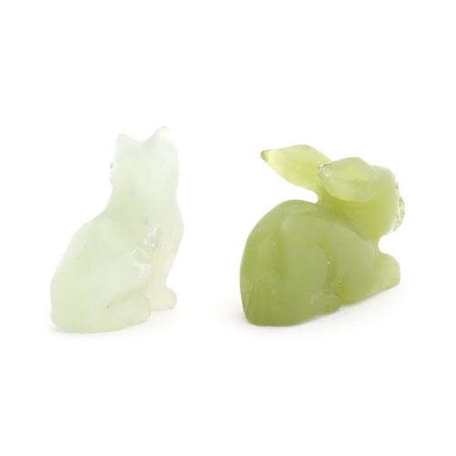 1011 - An Oriental carved jadeite model of a rabbit. Together with a carved bowenite model of a seated cat.... 