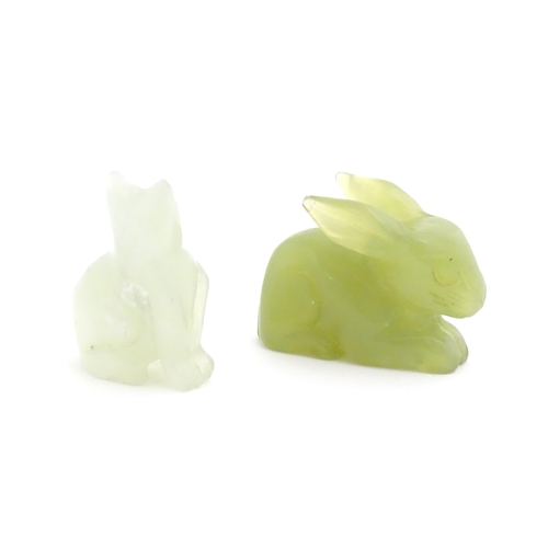 1011 - An Oriental carved jadeite model of a rabbit. Together with a carved bowenite model of a seated cat.... 