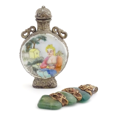 1014 - An Oriental snuff bottle with hand painted decoration depicting a woman in a garden scene. Together ... 