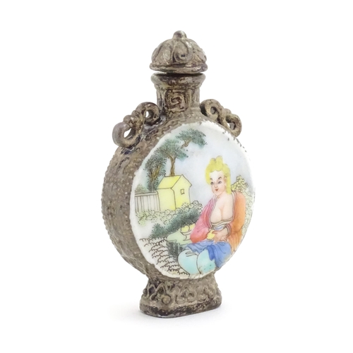 1014 - An Oriental snuff bottle with hand painted decoration depicting a woman in a garden scene. Together ... 