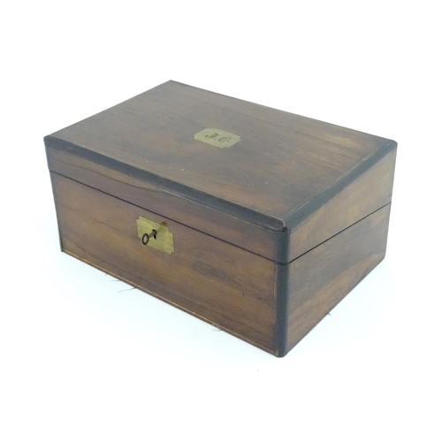 1016 - A Victorian walnut writing slope / box with brass banding and fitted interior. Approx. 6 1/2