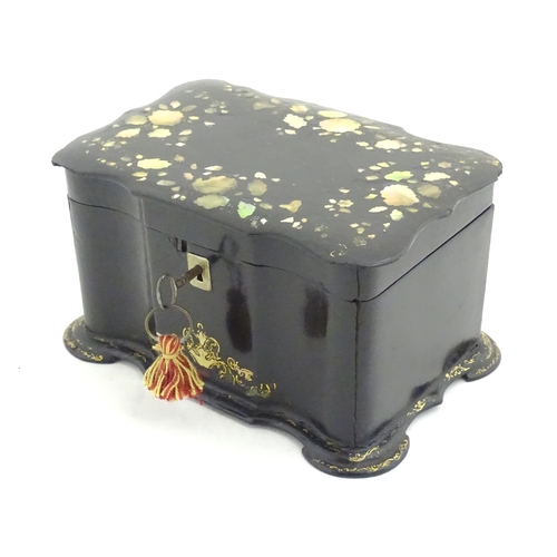 1023 - A Victorian papier mache tea caddy with inlaid abalone decoration, opening to reveal two lidded comp... 