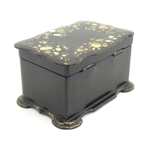 1023 - A Victorian papier mache tea caddy with inlaid abalone decoration, opening to reveal two lidded comp... 