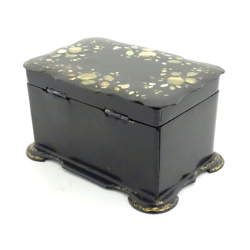 1023 - A Victorian papier mache tea caddy with inlaid abalone decoration, opening to reveal two lidded comp... 