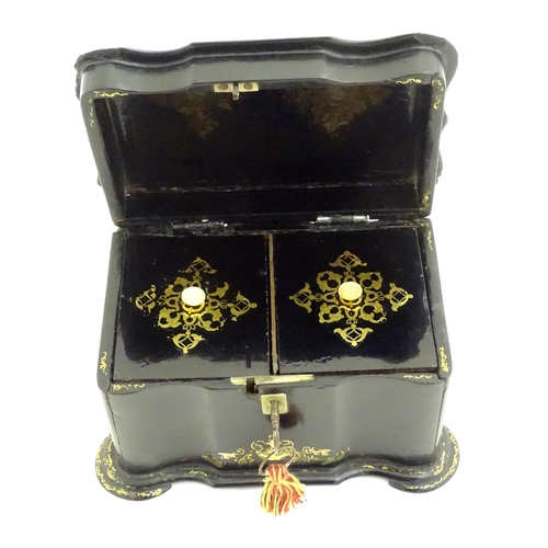 1023 - A Victorian papier mache tea caddy with inlaid abalone decoration, opening to reveal two lidded comp... 