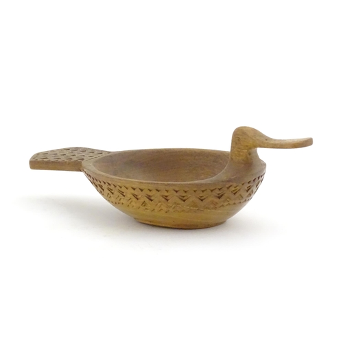 1024 - A Scandinavian folk art treen bowl / ale / grain measure modelled as a duck with banded geometric ch... 