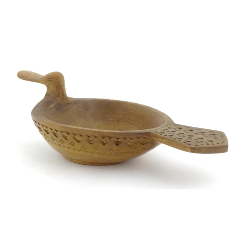 1024 - A Scandinavian folk art treen bowl / ale / grain measure modelled as a duck with banded geometric ch... 