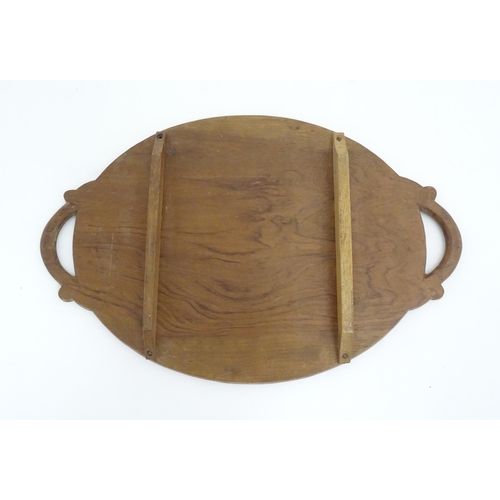 1025 - A carved wooden tray of oval form with scrolled handles, carved foliate decoration and seven section... 