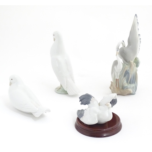 132 - Three Nao models of birds comprising Resting Herons, and two doves. Together with a Lladro Flutterin... 