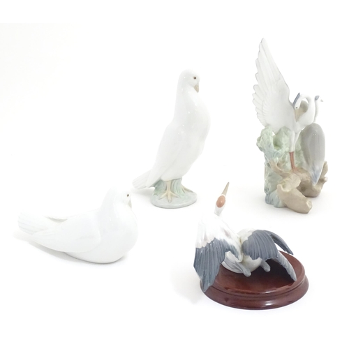 132 - Three Nao models of birds comprising Resting Herons, and two doves. Together with a Lladro Flutterin... 