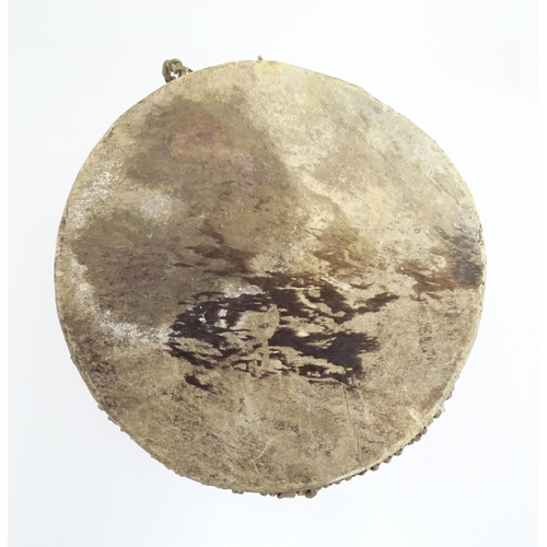 1045 - Ethnographic / Native / Tribal: An African animal hide drum raised on three legs. Approx. 14 1/4