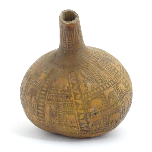 1046 - Ethnographic / Native / Tribal: An African gourd vase with incised decoration depicting elephants, z... 