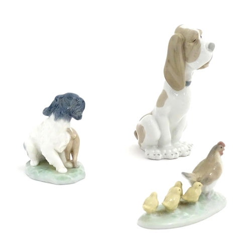 133 - Three Nao models of animals comprising a Basset Hound, a dog and cat 'In Harmony', and a chicken wit... 