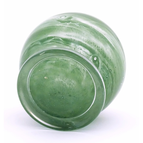 155 - An Art Deco Art Glass bowl with green swirled detail and circular foot. Approx 4